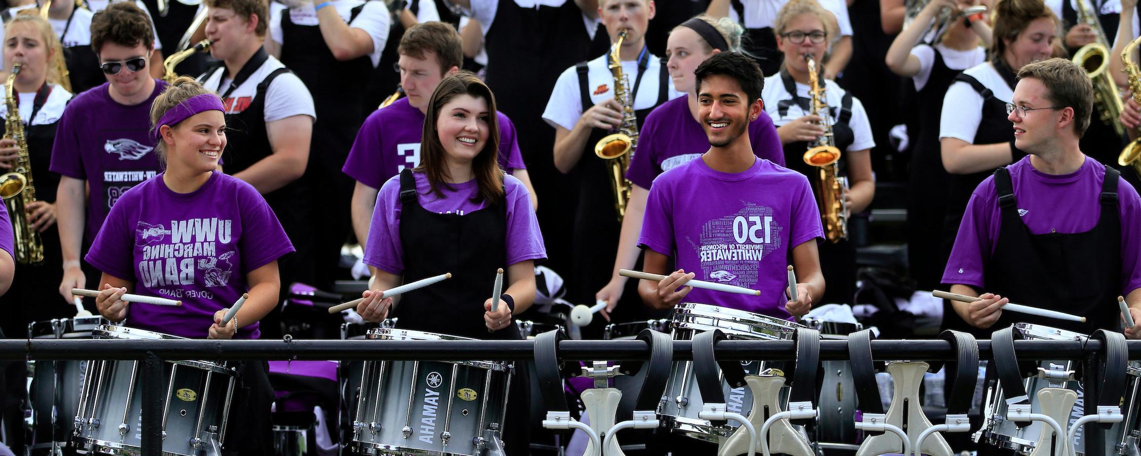 Warhawk Marching band plays in the stands of Perkins Stadium